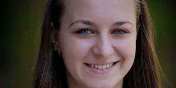 headshot of woman in black suit